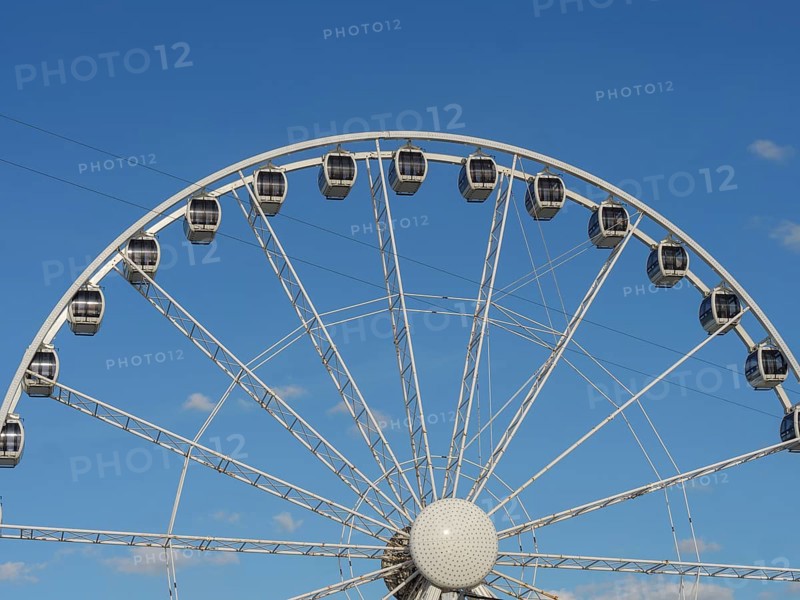Close-up of a Ferris wheel in front of a clear blue sky, the beach of scheveningen with pier and the promenade, scheveningen, the netherlands