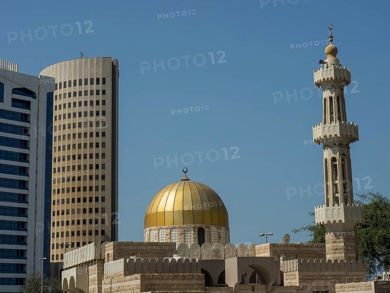 Islamic mosque with golden dome and minaret in front of modern skyscrapers, Abu Dhabi, United Arab Emirates, Asia