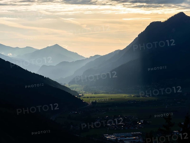 Sunlight falls on the Liesingtal valley and the village of Traboch, Schoberpass federal road, view from the lowlands, Leoben, Styria, Austria, Europe