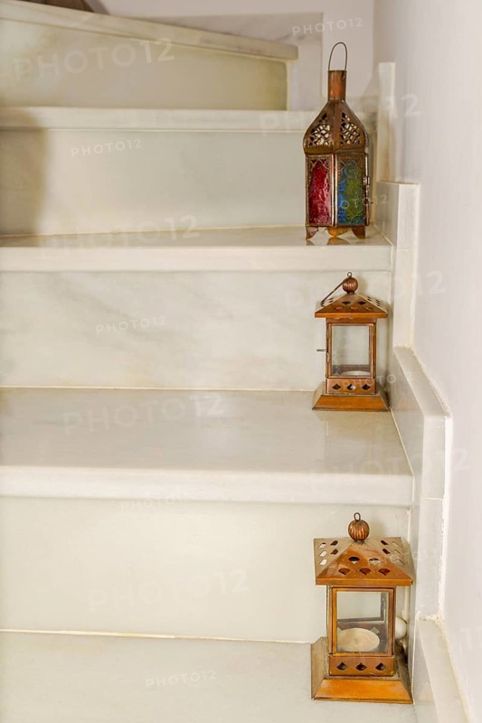 Various lanterns placed on the steps of a marble staircase