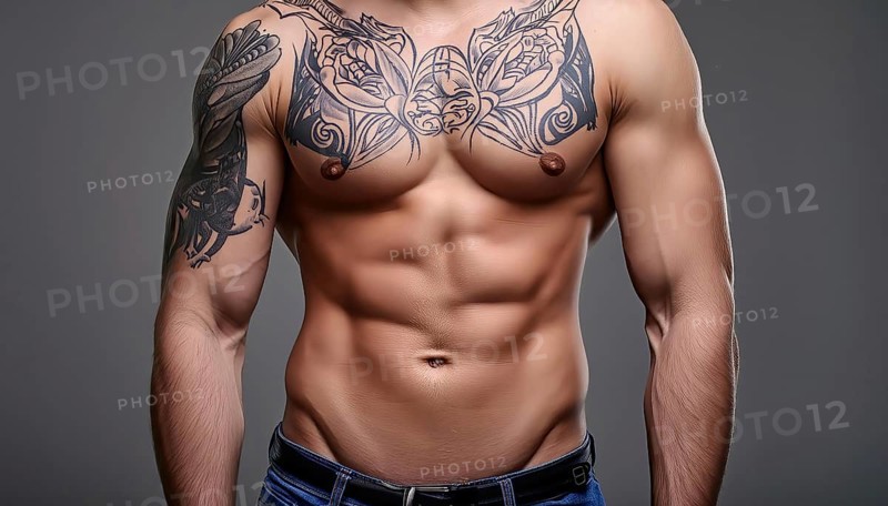 Man with muscular upper body and large tribal tattoos on chest and arms, wearing jeans, AI generated, AI generated