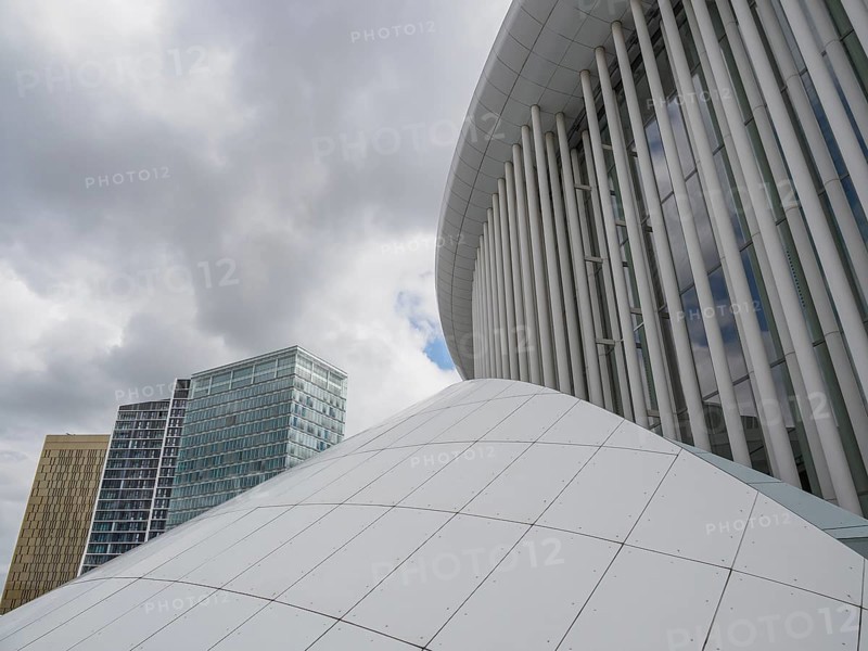 White dome and modern glass buildings in Luxembourg under a cloudy sky, modern buildings with trees and glass facades, luxembourg