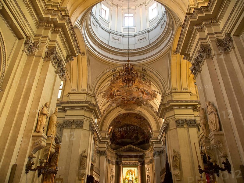 Magnificent nave with decorated dome and ornate columns, palermo in sicily with an impressive cathedral, monuments and old houses with balconies, palm trees and flowers in italy, palermo, sicily