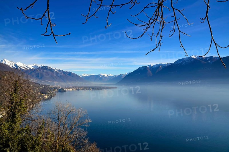 Panoramic View over Lake Maggiore with Snowcapped Mountain in a Misty Morning and in a Sunny Day in Ascona, Ticino, Switzerland, Europe