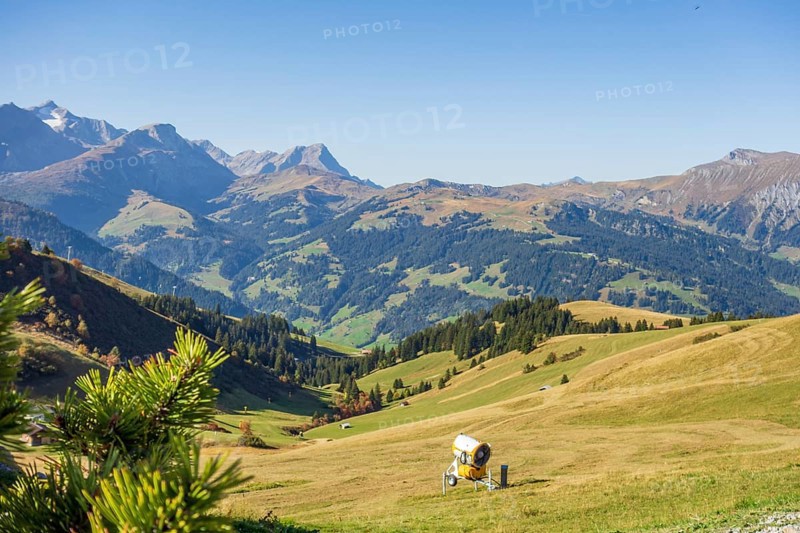 A picturesque mountain landscape with green hills and a blue sky in the sunshine, mountain panorama with rugged mountains and green valleys, saas fee, Switzerland, Europe