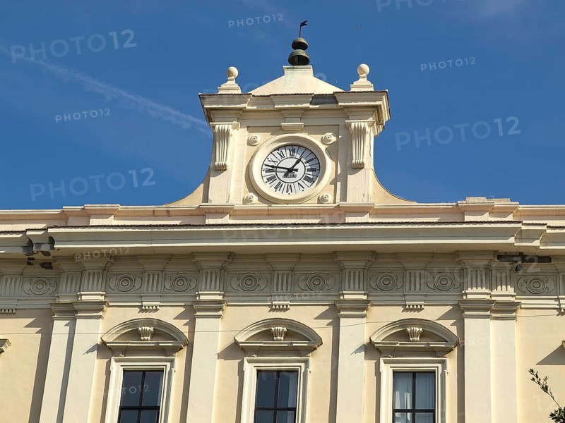 Historic clock tower with magnificent facade under a clear blue sky, The city of Bari on the Mediterranean with historic buildings, small harbour boats and beautiful churches, bari, italy