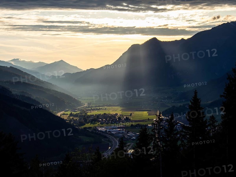 Sunlight falls on the Liesingtal valley and the village of Traboch, Schoberpass federal road, view from the lowlands, Leoben, Styria, Austria, Europe