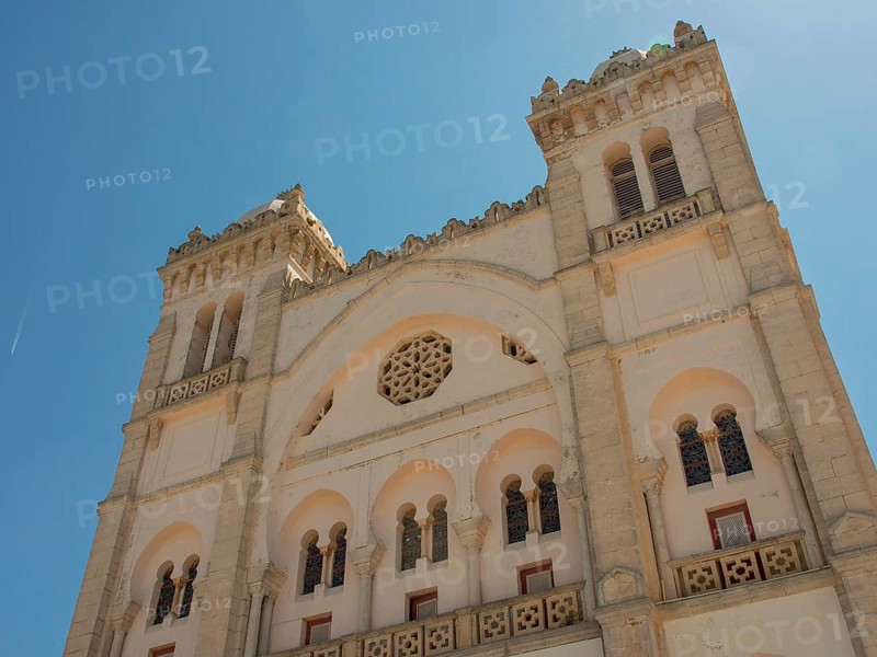 Front view of a large historic building with domes and beautiful decorations, Tunis in Africa with ruins from the Roman period, modern mosques and blue and white houses in sidi-bou-said, Tunis, Tunisia, Africa
