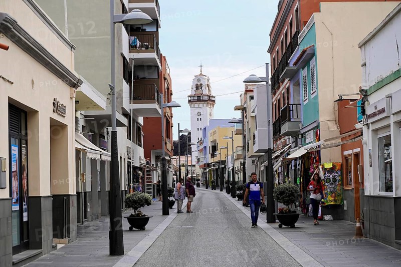 Candelaria, Tenerife, Canary Islands, Spain, Europe, A busy urban street lined with buildings with a church in the background, Europe