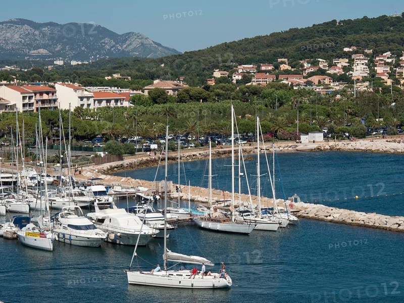 Marina with sailboats and mountains in the background in a picturesque coastal town, la seyne sur mer, france