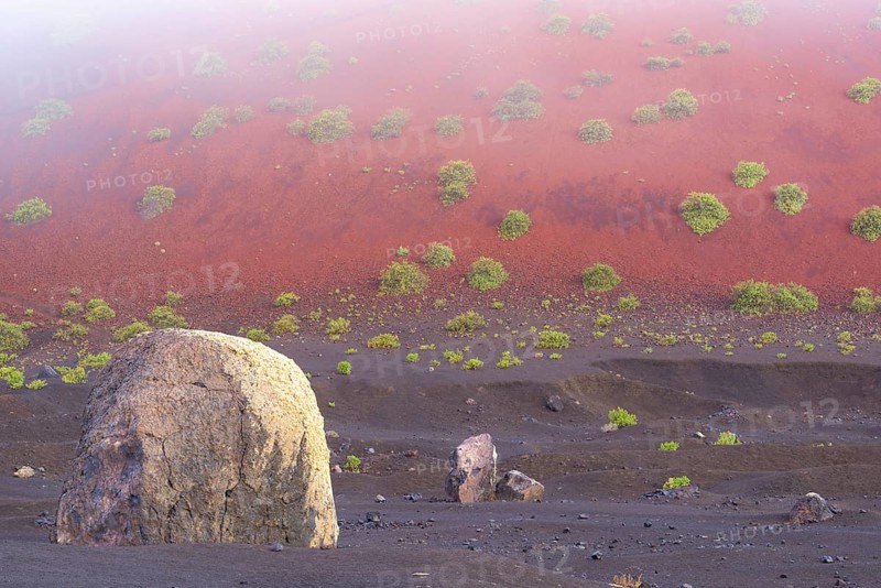 Lava bomb in front of Caldera Colorada, Parque Natural de Los Volcanes, near Masdache, Lanzarote, Canary Islands, Spain, Europe