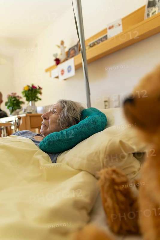 Senior citizen with dementia lying in her room in a retirement home, portrait, Baden-Wuerttemberg, Germany, Europe