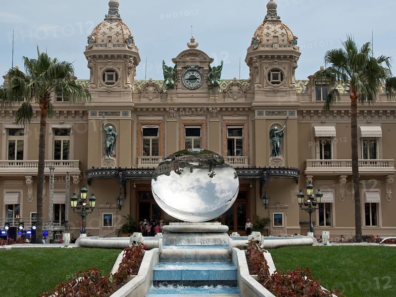 A magnificent palace with a mirror ball, surrounded by flowerbeds and a fountain, Monte Carlo, Monaco, Europe