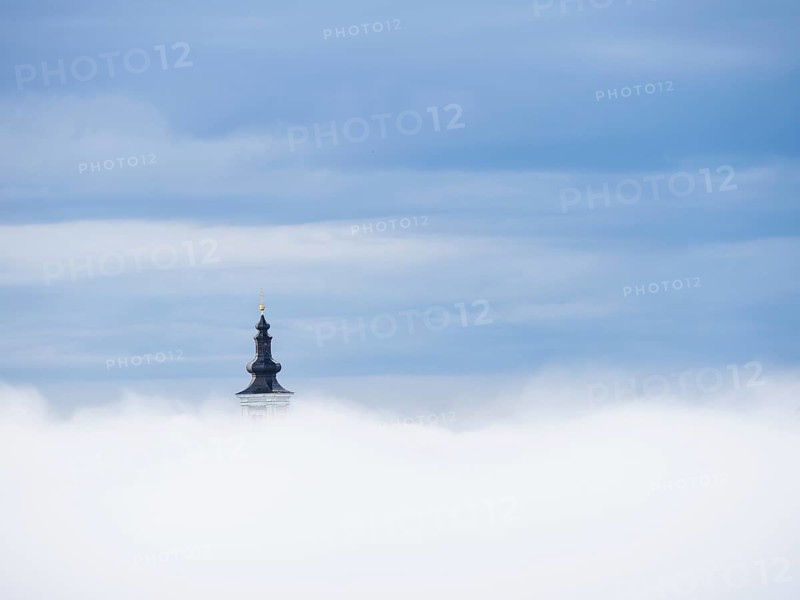 Church tower rises out of the morning mist, Frauenberg pilgrimage church, near Leibnitz, Styria, Austria, Europe