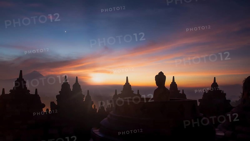 Buddha statue at sunrise, Borobudur temple complex, Borobudur, Yogyakarta, Java, Indonesia, Asia