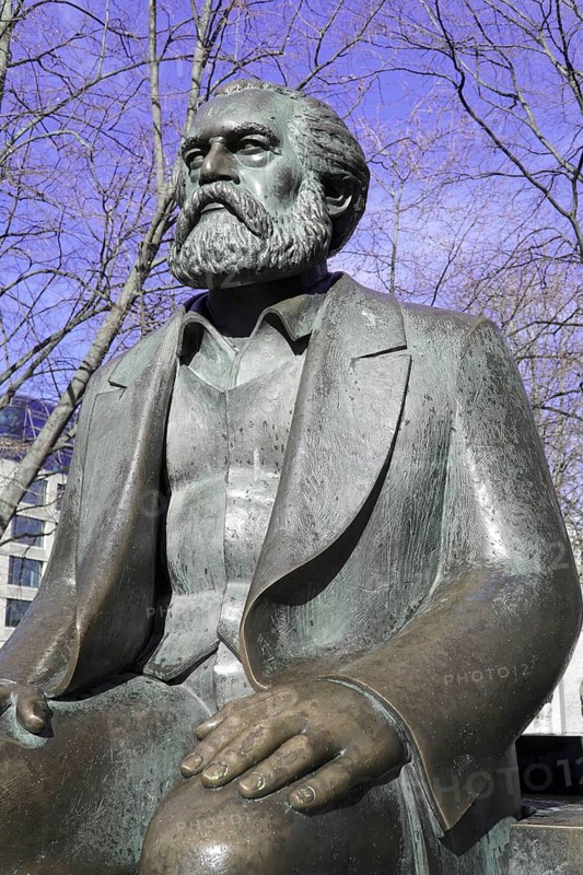 Bronze statues of Karl Marx and Friedrich Engels, Marx-Engels-Forum, Berlin, Germany, Europe, close-up of the statue of Karl Marx looking seriously into the distance, with trees in the background, Europe