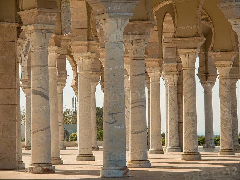 White columns and arches in historic Mediterranean architecture in the sunshine, Tunis in Africa with ruins from Roman times, modern mosques and blue and white houses in sidi-bou-said, Tunis, Tunisia, Africa