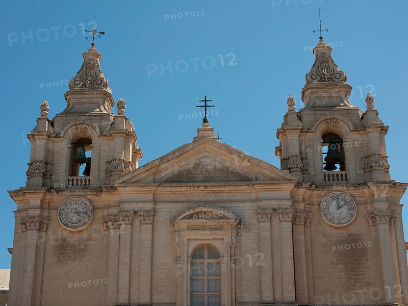 Front of a church with two heavily decorated bell towers and clocks, the town of mdina on the island of malta with historic houses, colourful balconies, magnificent churches, mdina, Malta, Europe