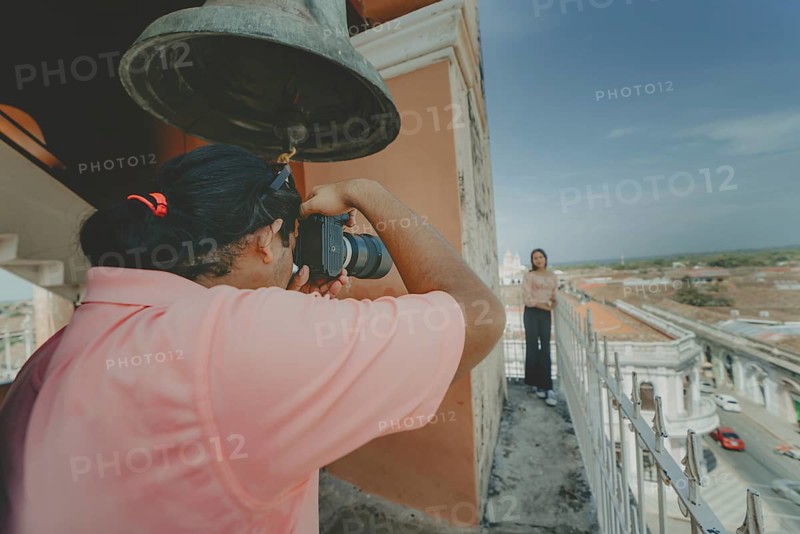 Tourists taking photographs at the viewpoint of the La Merced church, Granada. Tourist couple taking pictures at the viewpoint of the La Merced church