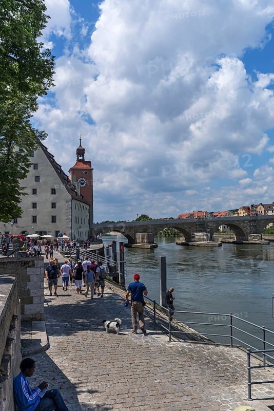 Danube promenade, behind the bridge tower museum with the Stone Bridge, Regensburg, Upper Palatinate, Bavaria, Germany, Europe