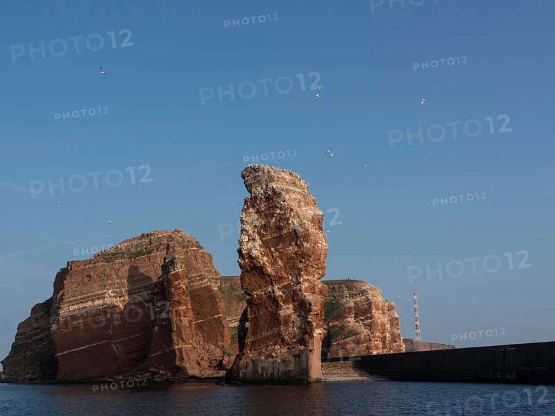 Dramatic cliff formations rise out of the sea into the sky, Heligoland, Germany, Europe