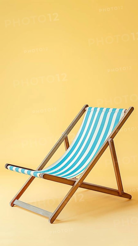 A blue and white striped beach chair with wooden legs. The chair is empty and is sitting on a yellow background, AI generated
