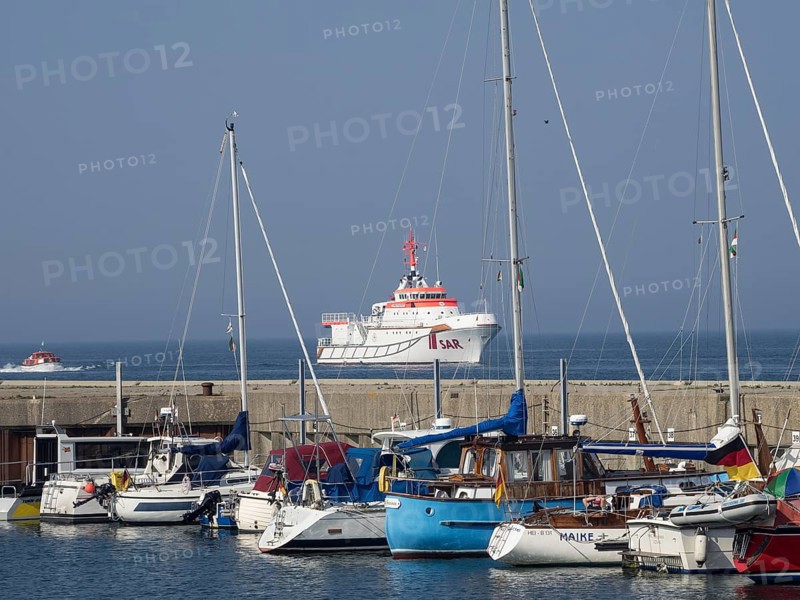 Harbour view with sailboats and a SAR rescue ship in the blue sea under a clear sky, Helgoland, Germany, Europe