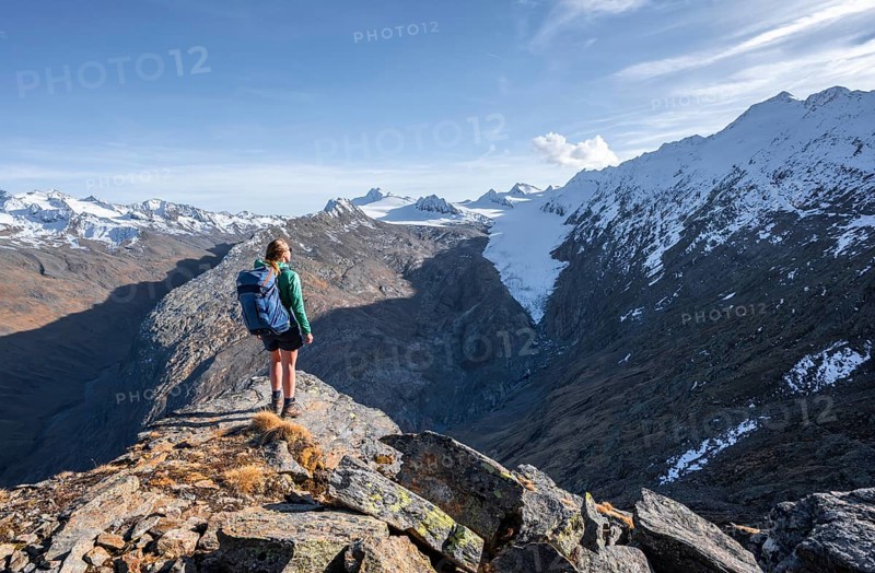 Hiker looking at mountain panorama and glacier, view of Gurgler Ferner with summit Hochwilde and Falschungsspitze, Oetztal Alps, Tyrol, Austria, Europe