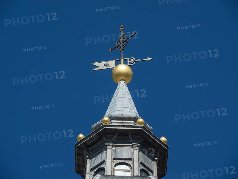 Detailed view of a church tower with a golden weather vane under a clear blue sky, Madrid, Spain, Europe