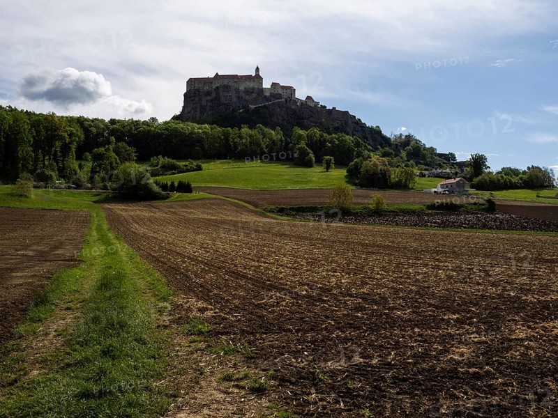 Clods of earth in farmland, Riegersburg Castle in the background, near Riegersburg, Styria, Austria, Europe