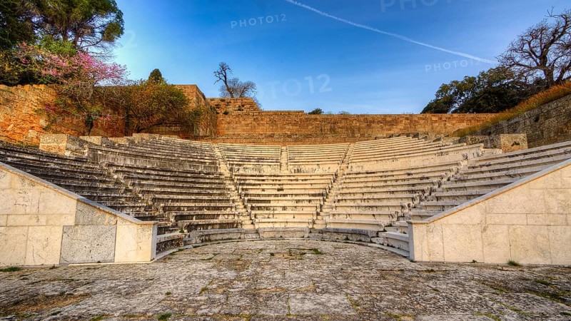 Ancient amphitheatre with stone seating steps, illuminated by soft morning sunlight, Archaeological Site, Rhodes Town, Rhodes, Dodecanese, Greek Islands, Greece, Europe