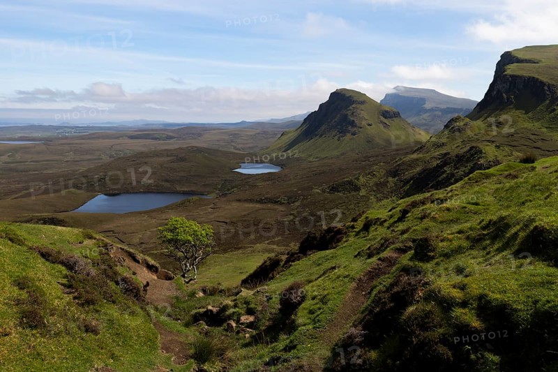 Quiraing, landscape in Scotland, mountainousWide mountain landscape with lakes and valleys under a slightly cloudy sky