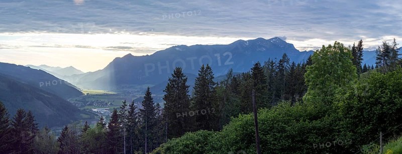 Sunlight falls on the Liesingtal valley and on the village of Traboch, Schoberpass federal road, panoramic photo, view from the lowlands, Leoben, Styria, Austria, Europe