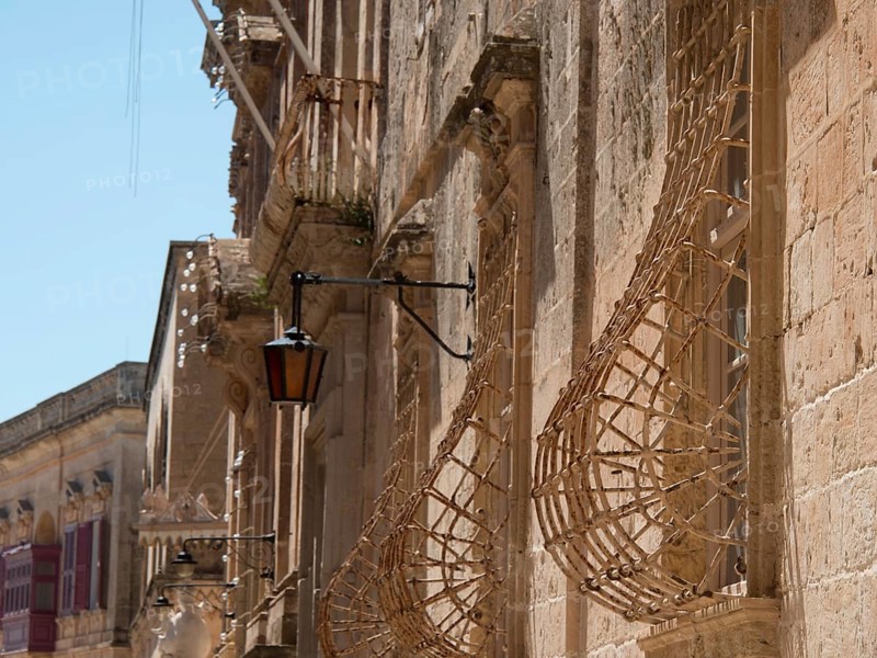 Historic street with stone facades and lanterns in a sunny town, the town of mdina on the island of malta with historic houses, colourful balconies, magnificent churches, mdina, Malta, Europe