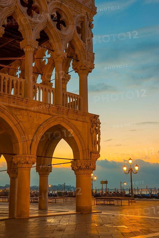 Beautiful Ducal Palace with Arches and Street Lamps and Gondola in San Marco Square in Sunset in Venice, Veneto, Italy, Europe