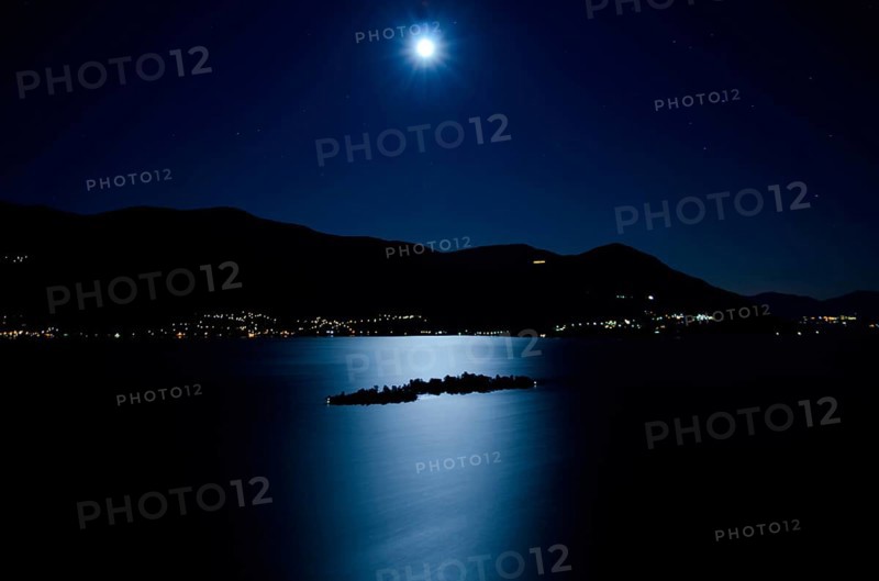 Aerial View with Moon Light Reflected over an Alpine Lake Maggiore with Brissago Islands and Mountain at Night in Ticino, Switzerland, Europe