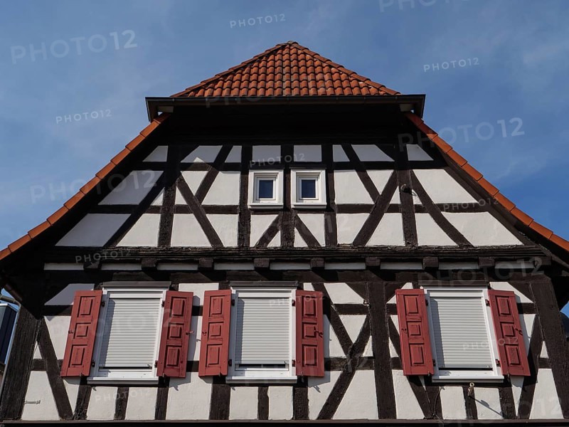 Half-timbered house with red shutters and tiled roof, under a clear blue sky, historic half-timbered houses in the Palatinate, kandel, Germany, Europe