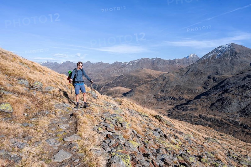 Mountaineer on a hiking trail, Gurgler Seenplatte, behind mountain peak of the Gurgler ridge, in autumn, near Obergurgl, Oetztal Alps, Tyrol, Austria, Europe