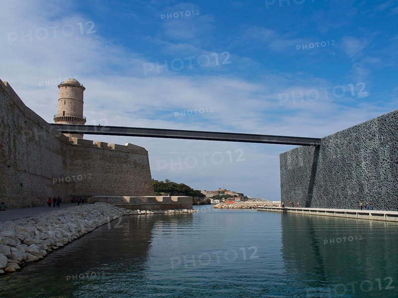 Historic castle with bridge and moat, winter sky in the background, Marseille on the Mediterranean Sea with the old cathedral and ships in the historic harbour, rocky coast on the Mediterranean Sea, marseille, france