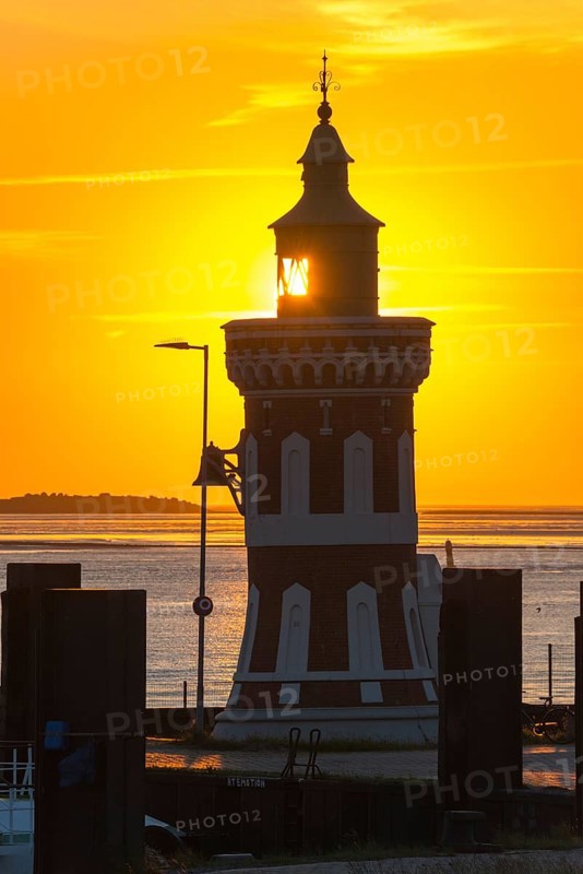 Pingelturm, historic lighthouse with bell in the harbour, close-up, atmospheric, golden, beautiful sunset, silhouette against the calm sea and the warm light of the sky, bright orange, in the background the island Langluetjen II, twilight, evening, dusk, maritime, calm atmosphere, mouth of the Weser into the North Sea, Outer Weser, coast, Bremerhaven, Land Bremen, Germany, Europe