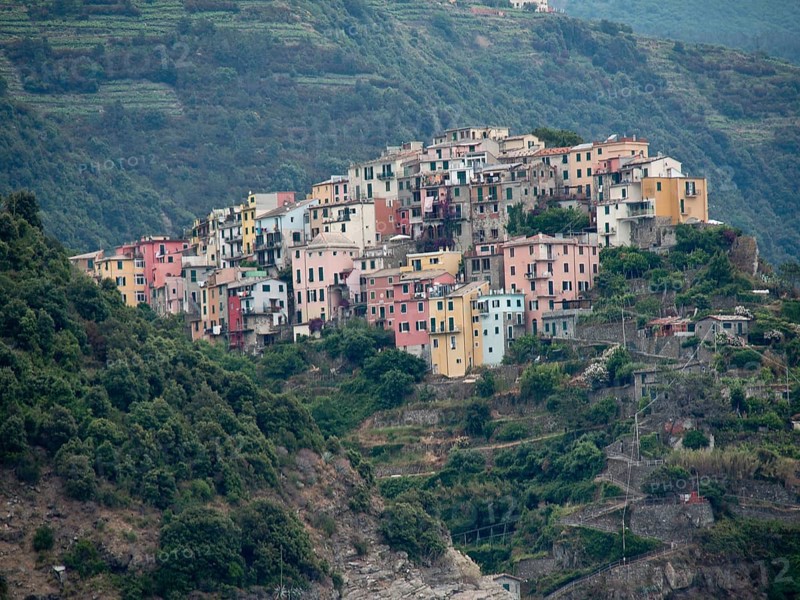 A mountain village with colourful houses nestled in green terraces and nature, Bari, Italy, Europe