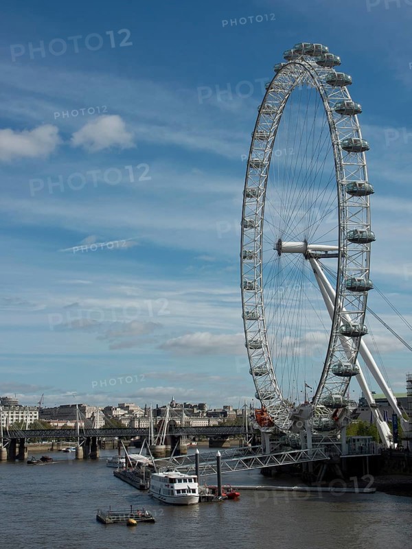 The London Eye next to the Thames under a slightly cloudy sky, London, England, United Kingdom, Europe