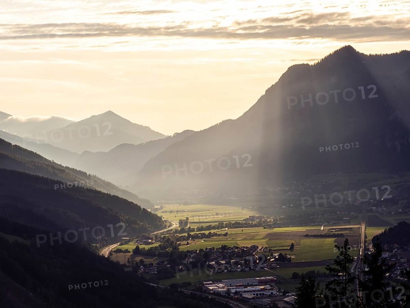 Sunlight falls on the Liesingtal valley and the village of Traboch, Schoberpass federal road, view from the lowlands, Leoben, Styria, Austria, Europe