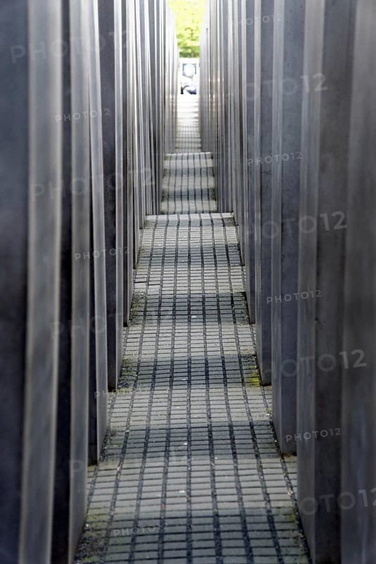 Holocaust memorial in Berlin, Germany Holocaust memorial in Berlin, Germany, Europe, Long narrow path between high grey concrete walls leading into the distance, Europe