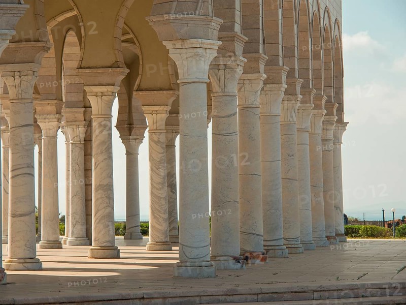 Row of stone columns of an arcaded structure, sky and landscape in the background, Tunis in Africa with ruins from Roman times, modern mosques and blue and white houses in sidi-bou-said, Tunis, Tunisia, Africa