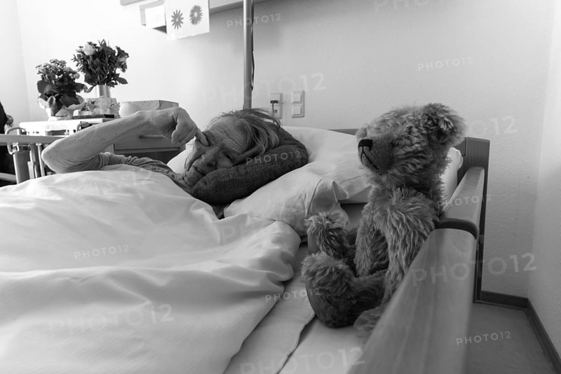 Senior citizen with dementia lying in her room in a retirement home, portrait, Baden-Wuerttemberg, Germany, Europe