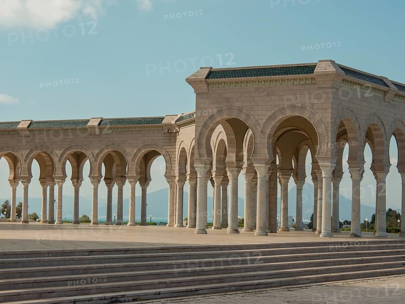 An exterior stone structure with arches and columns under a sunny sky, Tunis in Africa with Roman ruins, modern mosques and blue and white houses in sidi-bou-said, Tunis, Tunisia, Africa