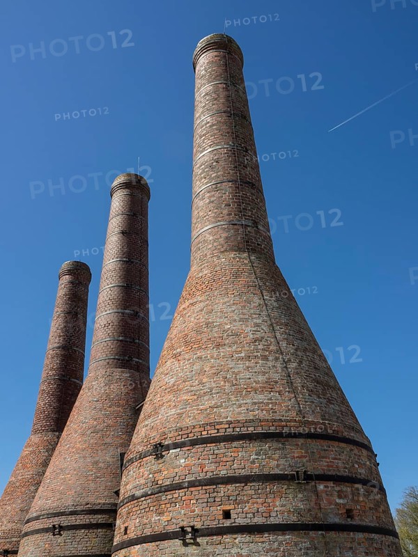 Close-up of three tall brick chimneys against a clear sky, Enkhuizen, Nirderlande
