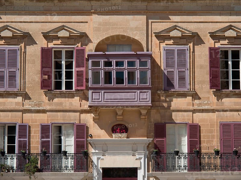 Building facade with purple shutters and small balconies, the town of mdina on the island of malta with historic houses, colourful balconies, magnificent churches, mdina, Malta, Europe