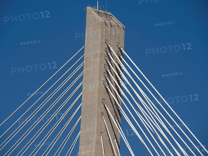 Modern cable-stayed bridge with a high concrete tower and numerous steel cables under a clear sky, the old town of Dubrovnik with historic houses, churches, red roofs and fortress walls, dubrovnik, coratia